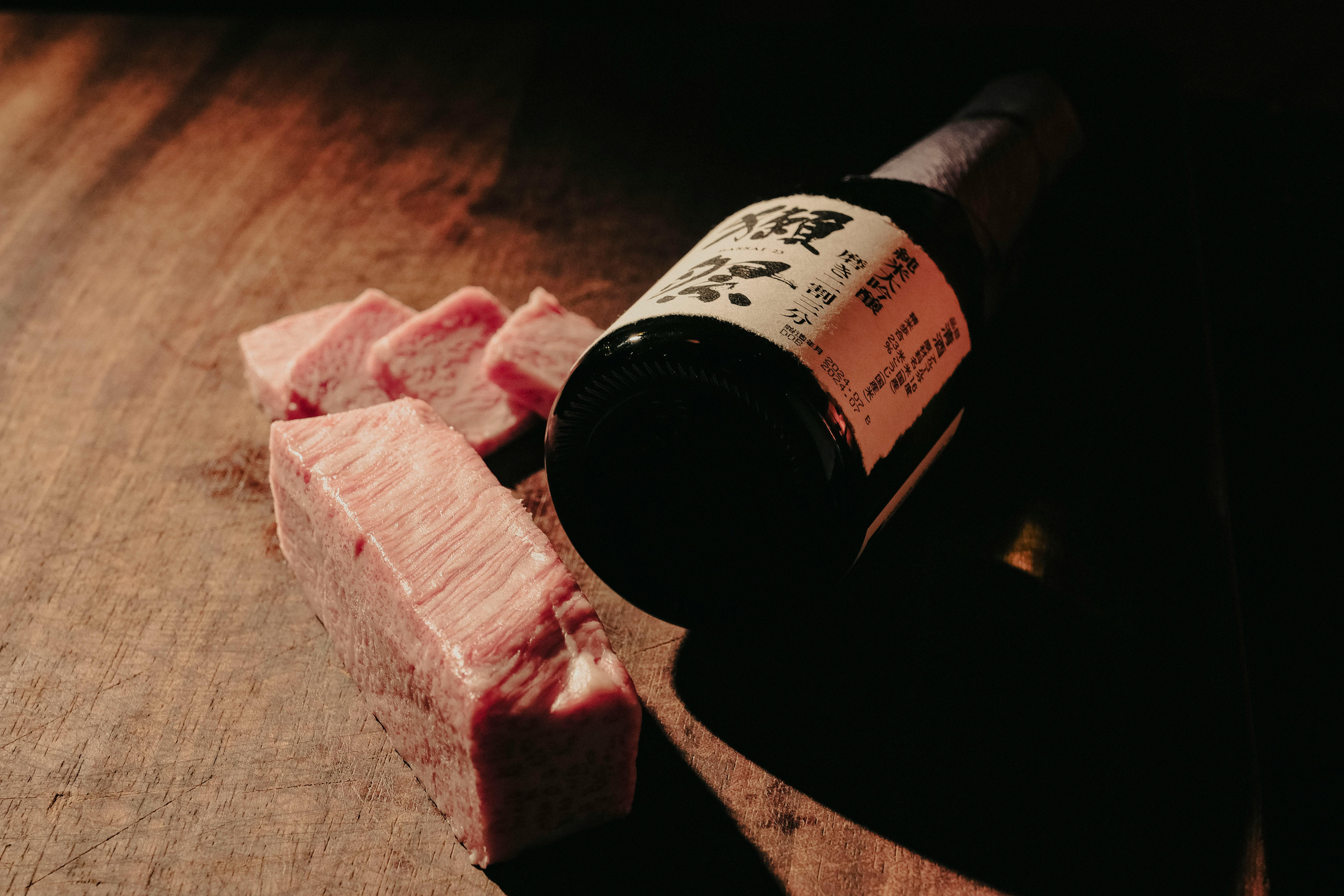 Fresh raw beef steak on black plate.